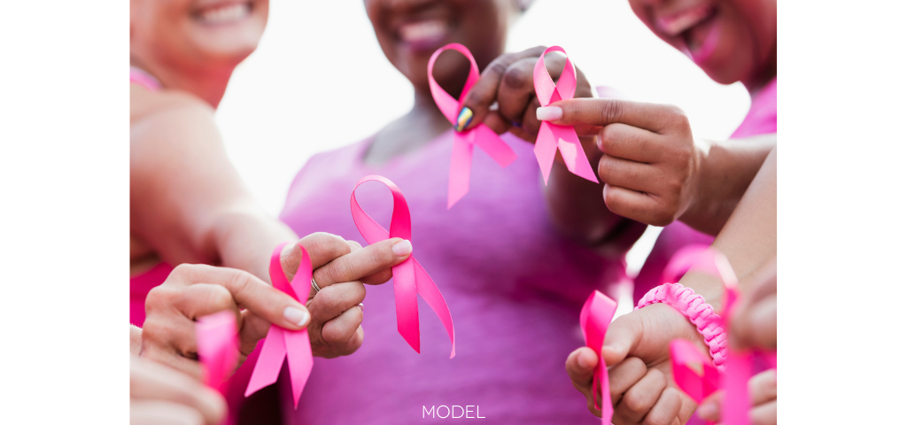 women with pink ribbons