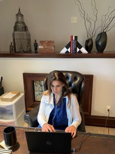 Dr. Amalfi conducting telemedicine consults in her home office.
