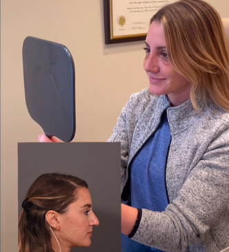 woman looking in hand held mirror