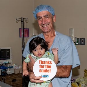Dr. Koenig and a child on a HUGS medical mission trip.