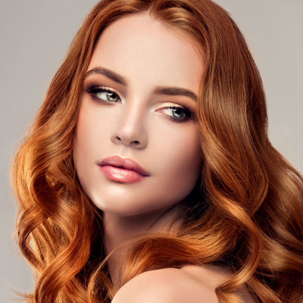 female model with red hair looking over shoulder