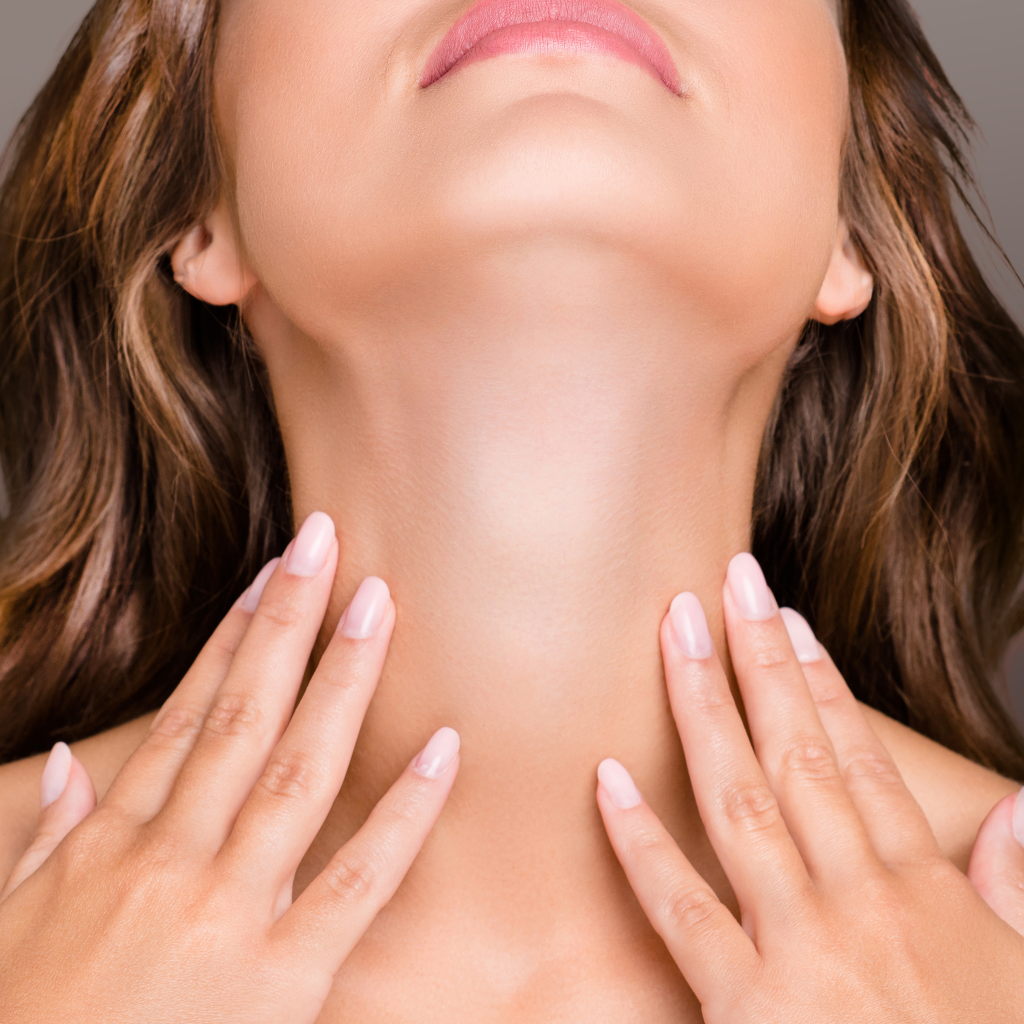 Image of a woman with uplifted chin on hands on the base of her neck